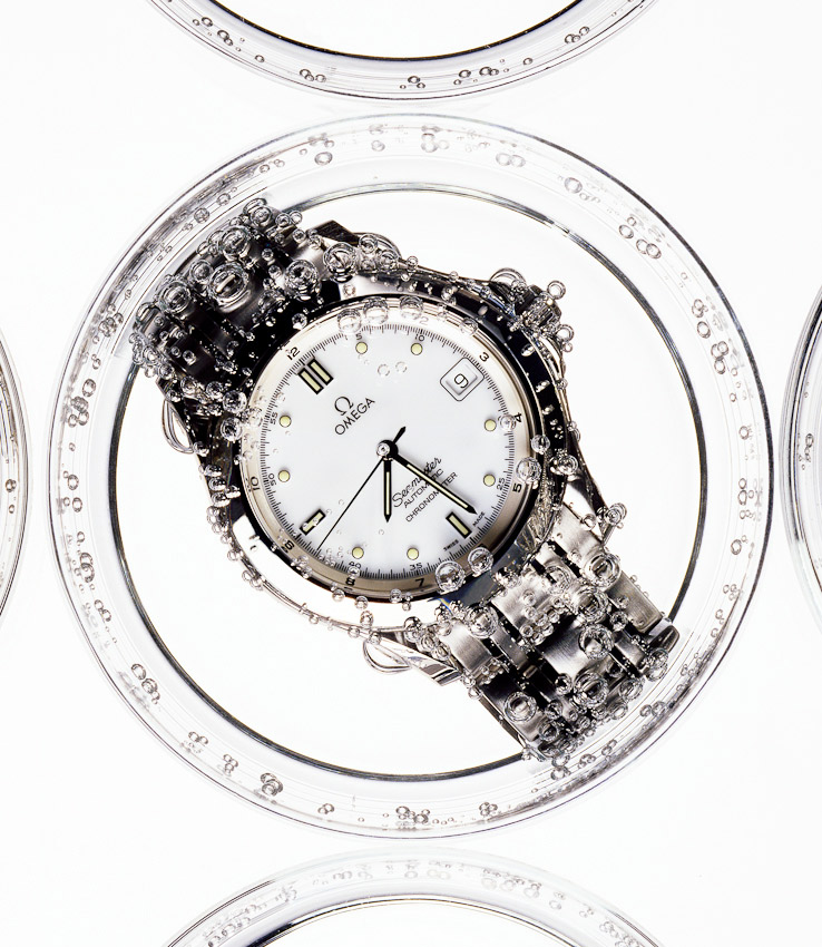 close up of a watch underwater with bubbles, watches and jewellery still life, watches and jewellery, luxury accessories, watch photography, luxury women's accessories photography, still-life photography, David Parfitt, still-life, still-life photography, still-life photographer, still-life photographer London, David Parfitt, advertising photographer